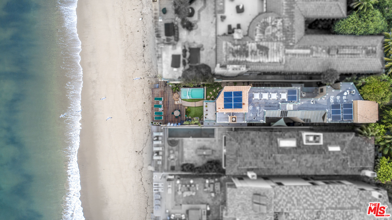 23768 Malibu Road Malibu, CA 90265 - Photo 21 of 23 a kitchen with stainless steel appliances kitchen island granite countertop a stove a sink and a white cabinets