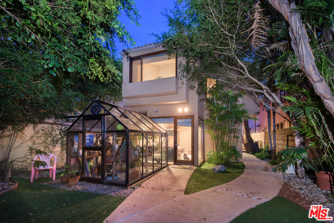 23768 Malibu Road Malibu, CA 90265 - Photo 6 of 23 a view of a house with a small yard and a large tree