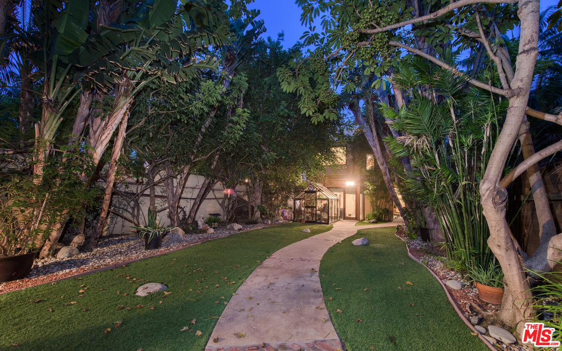 23768 Malibu Road Malibu, CA 90265 - Photo 7 of 23 a view of a yard with plants and large trees