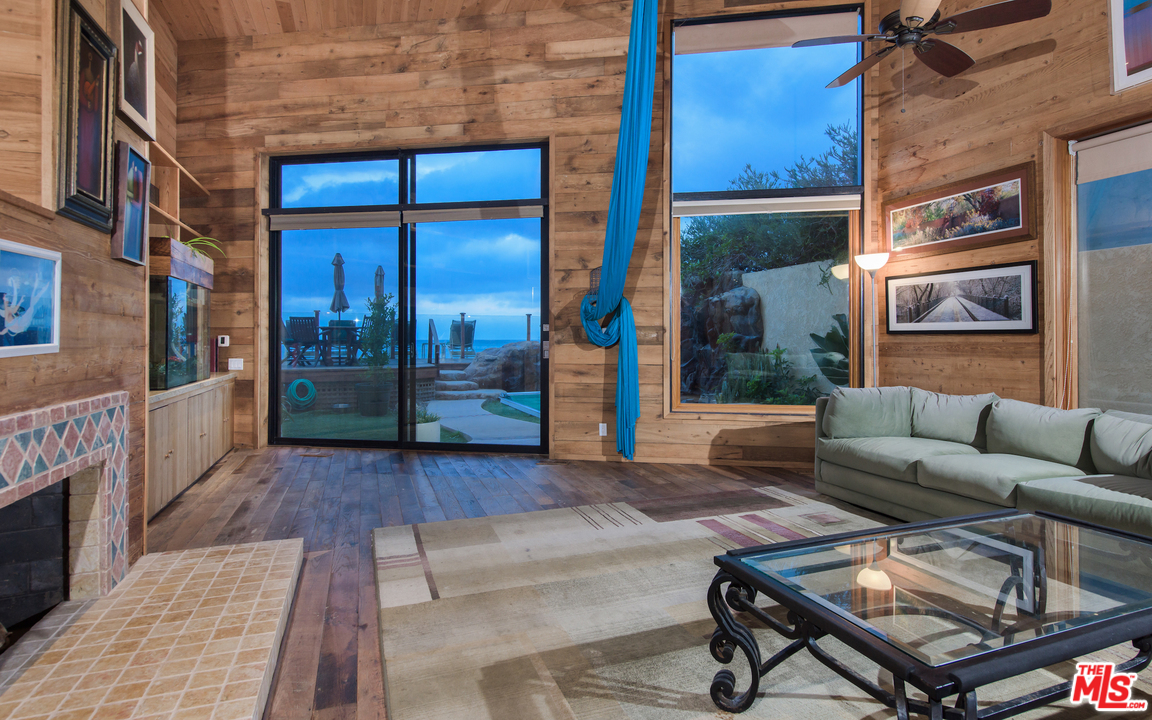 23768 Malibu Road Malibu, CA 90265 - Photo 10 of 23 a view of a building with a couch and wooden floor