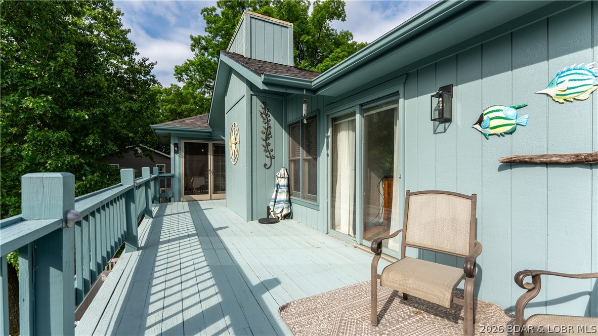 490 Waterfowl Road Linn Creek, MO 65052 - Photo 16 of 52 Dining and Primary Opens to Lakeside Deck