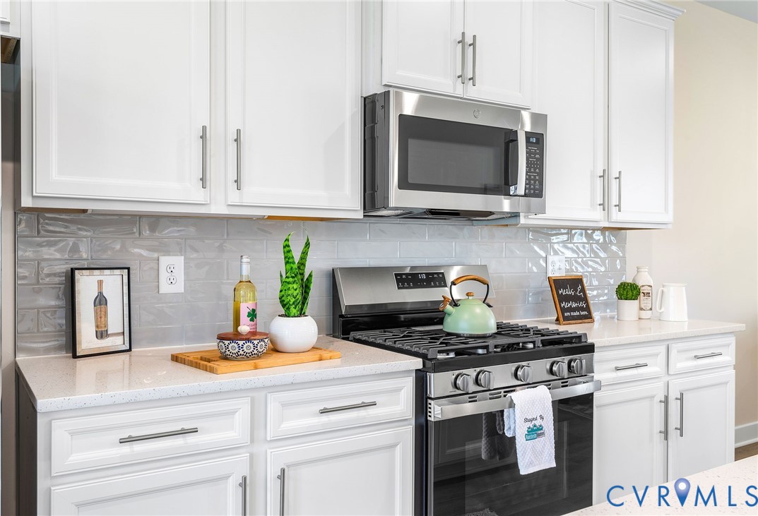 1255 Lazy River Road Midlothian, VA 23114 - Photo 12 of 27 a kitchen with a stove and a white cabinets