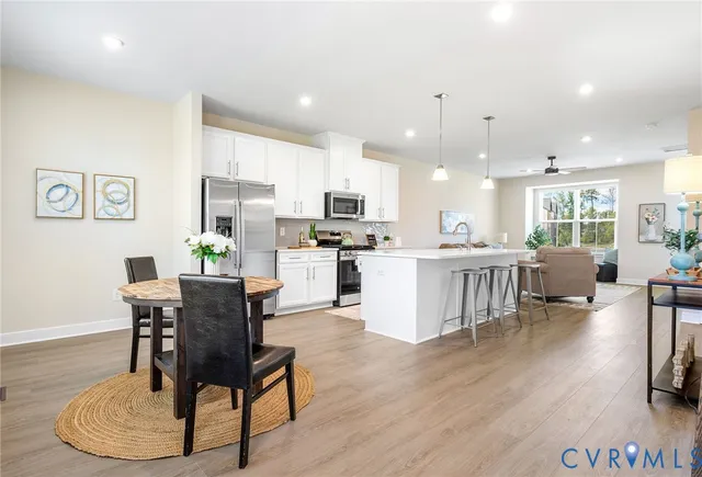 a living room with furniture and kitchen view