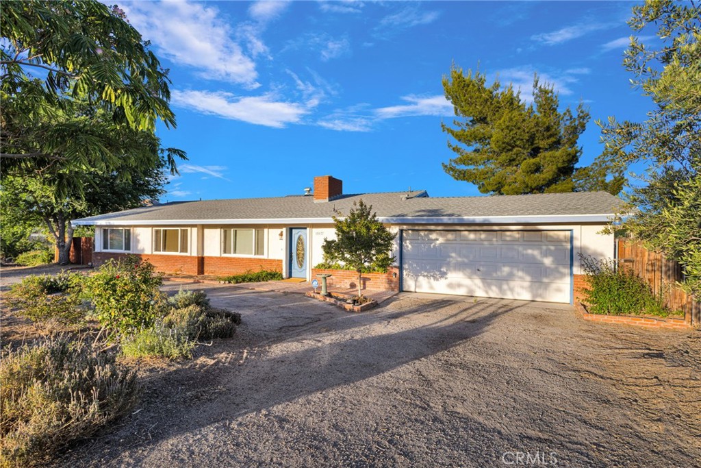 15177 Mendota Road North Apple Valley, CA 92307 - Photo 32 of 50 a front view of a house with a yard and potted plants