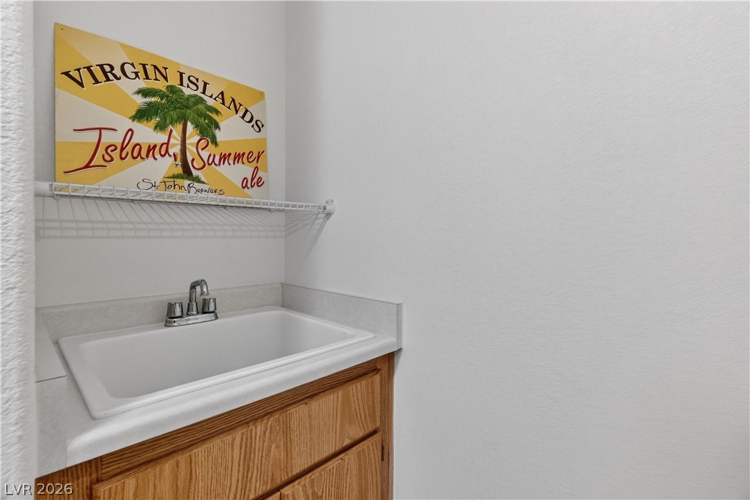 3376 Partridge Run Street Laughlin, NV 89029 - Photo 43 of 92 A utilitarian sink area in the laundry room provides practical space for household tasks.