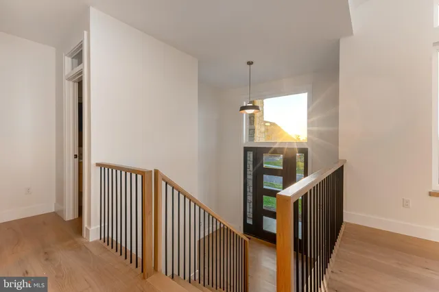 a large kitchen with a large counter top a sink stainless steel appliances and cabinets
