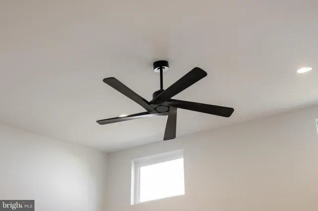 a view of an empty room with a kitchen