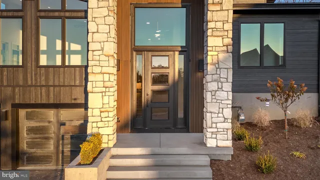 a view of a hallway with wooden floor and stairs