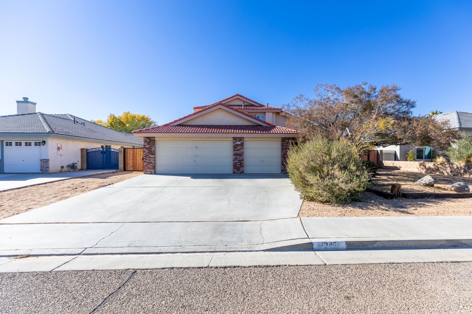 1047 Carolyn Street Ridgecrest, CA 93555 - Photo 1 of 35 a front view of a house with a garden
