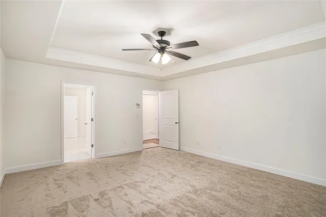 an empty room with a window and a ceiling fan