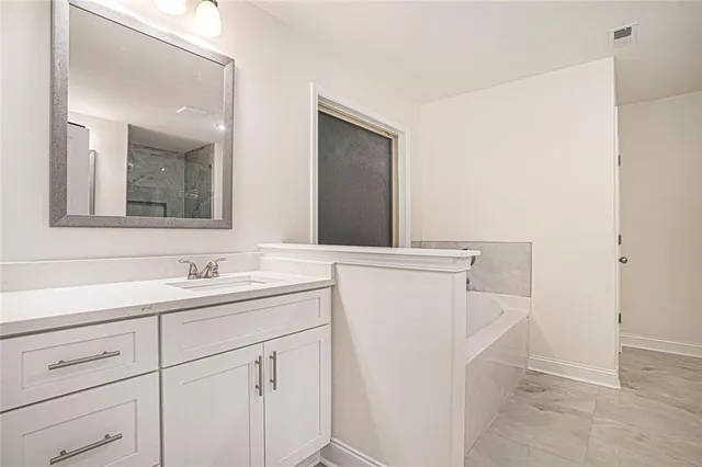 a white bath tub sitting next to a white sink