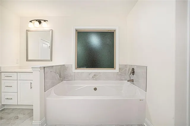 a bathroom with a shower sink and mirror