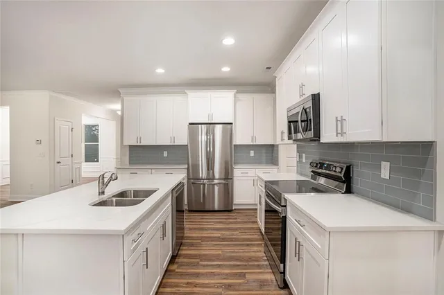 a kitchen that has a sink a stove and refrigerator