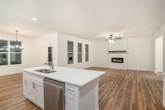 a kitchen that has a sink and a stove top oven