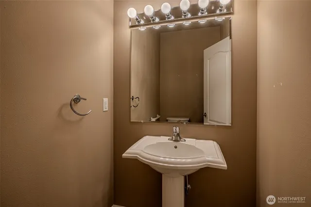a bathroom with a sink a mirror and shower view