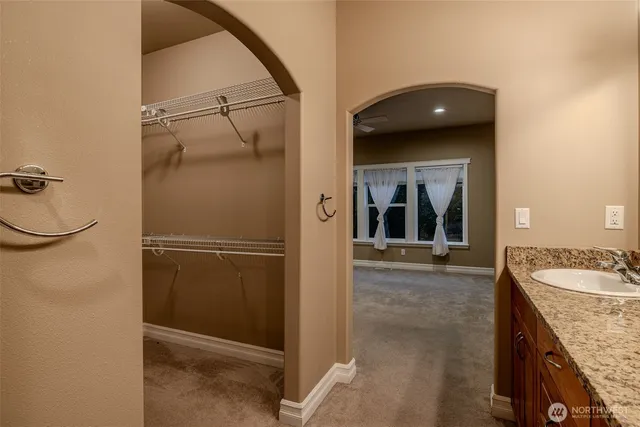 a bathroom with a granite countertop shower and a sink