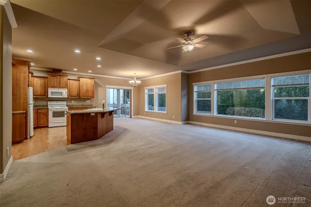 a large kitchen with stainless steel appliances granite countertop a stove sink and cabinets