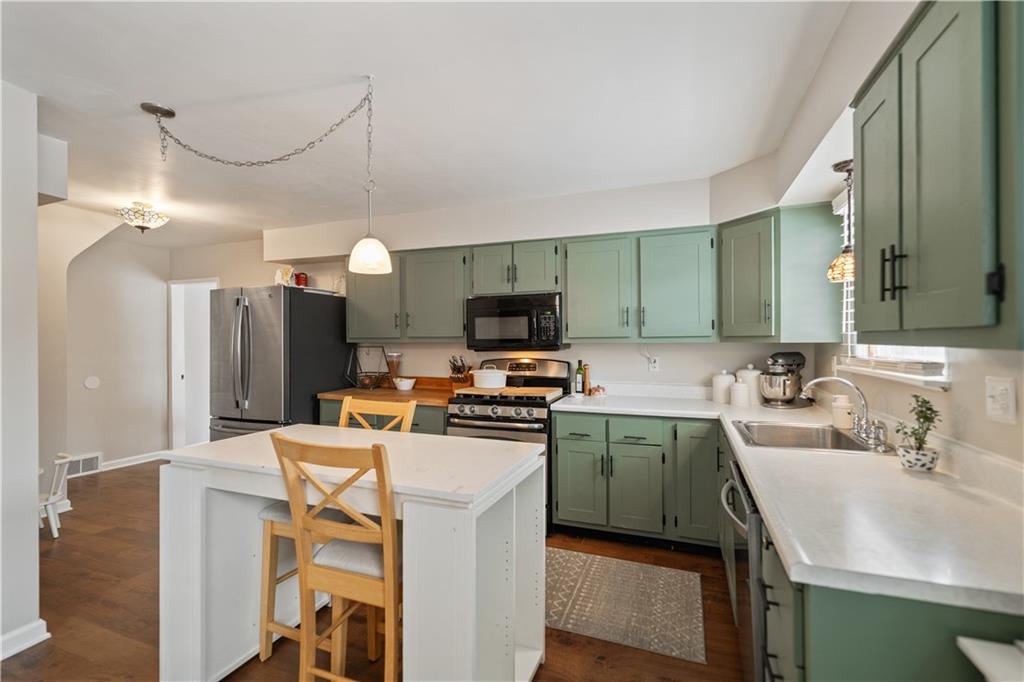 315 Vanadium Road Pittsburgh, PA 15243 - Photo 11 of 39 a kitchen with a sink a counter top space stainless steel appliances and cabinets