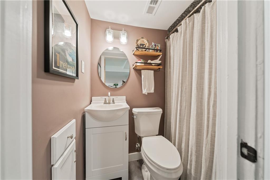 315 Vanadium Road Pittsburgh, PA 15243 - Photo 27 of 39 a bathroom with a toilet a sink and a mirror