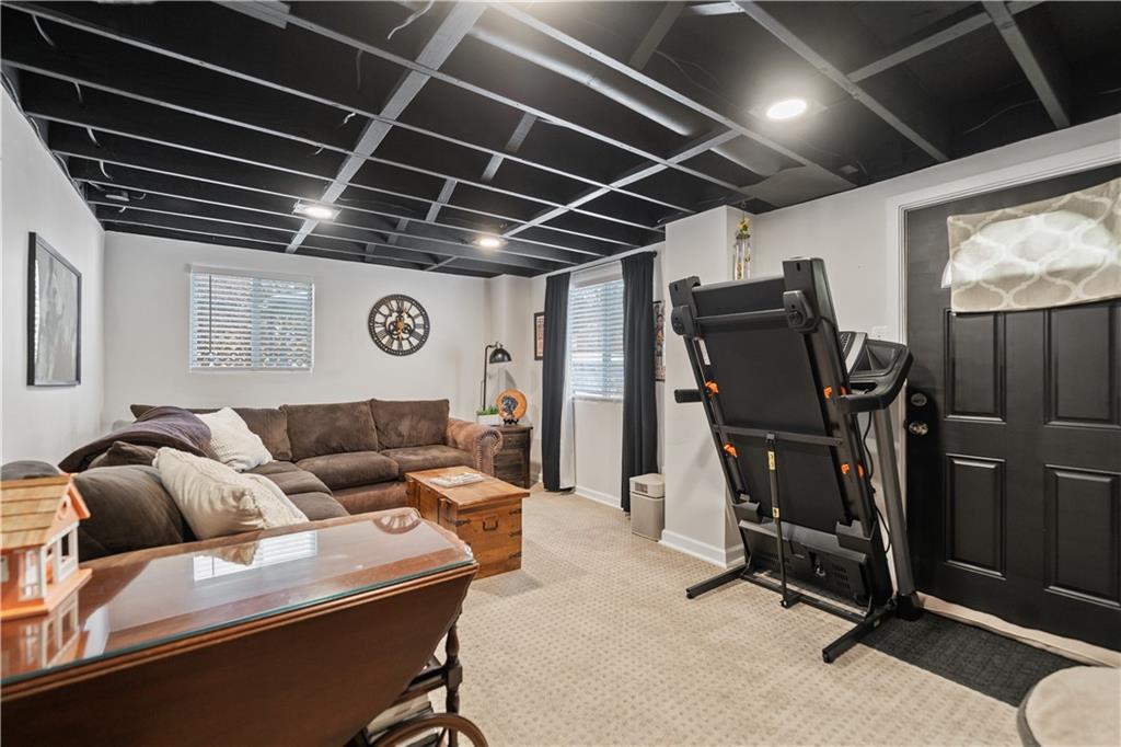 315 Vanadium Road Pittsburgh, PA 15243 - Photo 29 of 39 a living room with furniture gym equipment and a window
