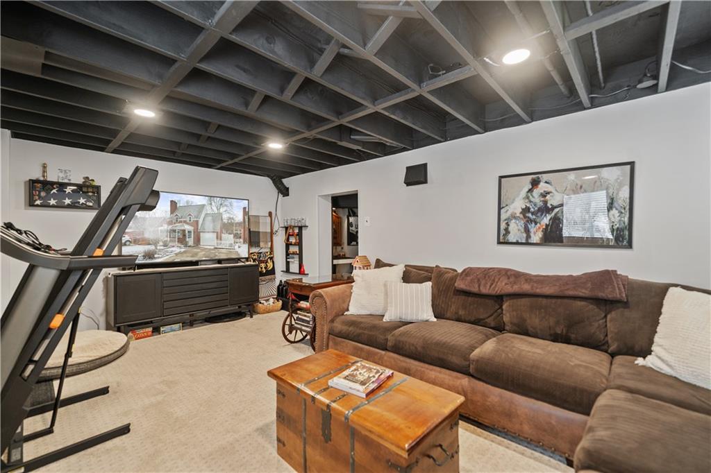 315 Vanadium Road Pittsburgh, PA 15243 - Photo 30 of 39 a living room with furniture a air conditioner and a flat screen tv