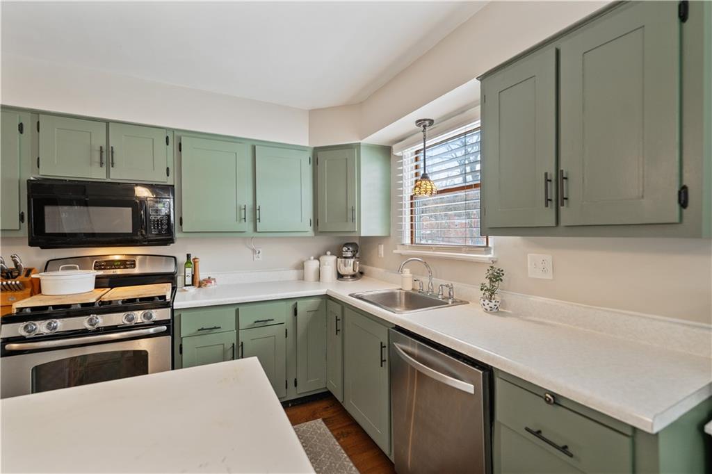 315 Vanadium Road Pittsburgh, PA 15243 - Photo 10 of 39 a kitchen with a sink and a stove top oven
