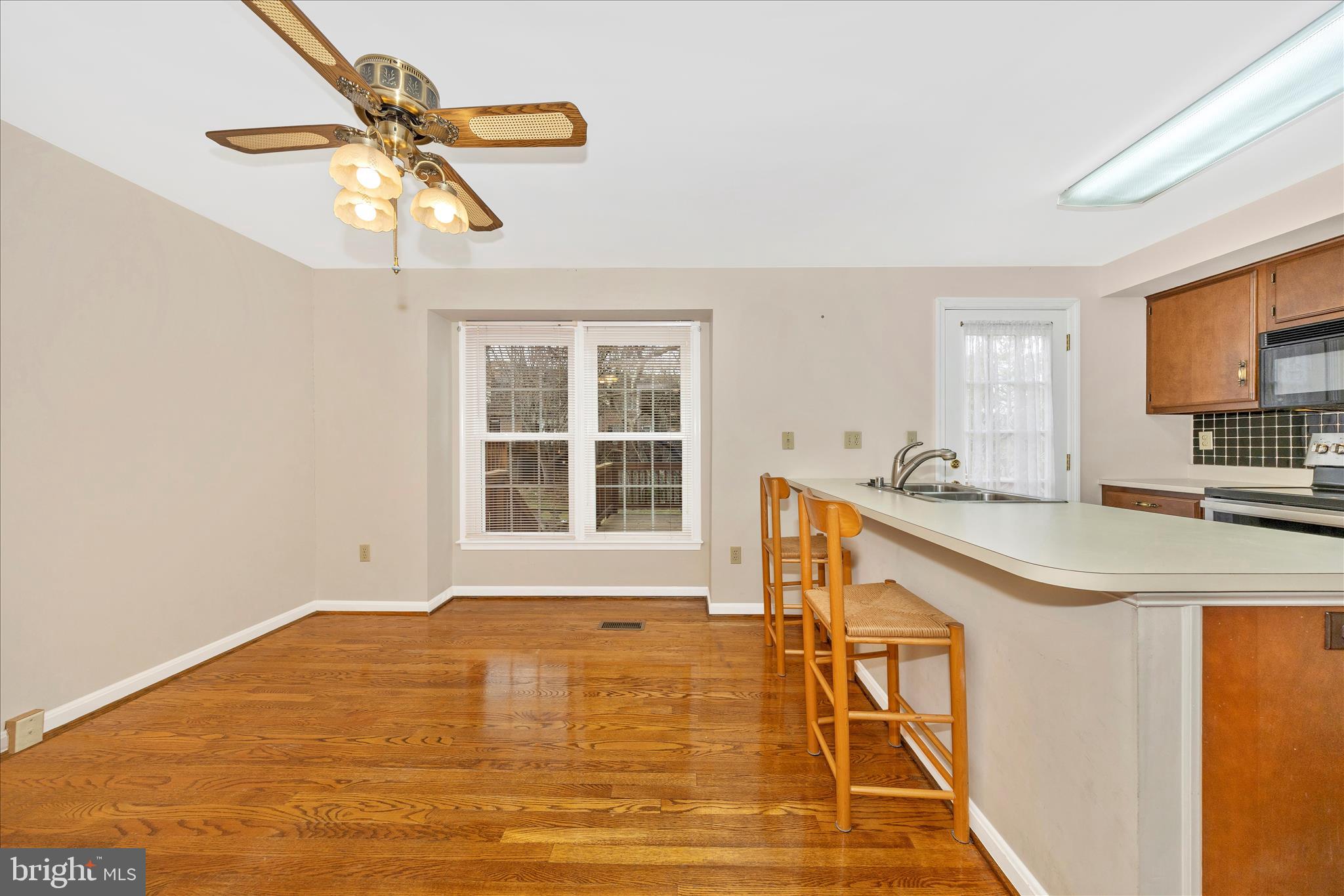 8007 Broken Reed Court Frederick, MD 21701 - Photo 13 of 72 a view of a kitchen with a sink and dishwasher with wooden floor