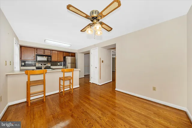 a kitchen with a table chairs refrigerator and sink
