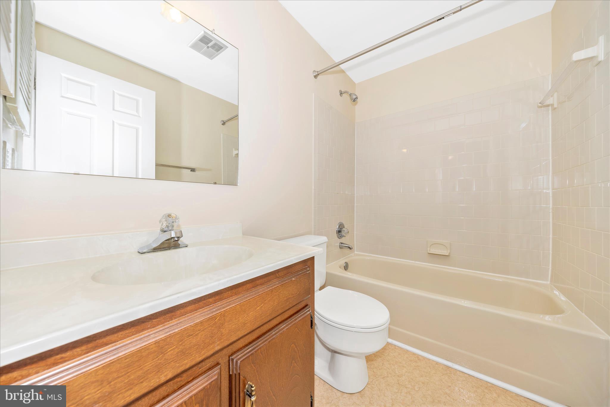 8007 Broken Reed Court Frederick, MD 21701 - Photo 21 of 72 a bathroom with a granite countertop sink toilet a mirror and shower