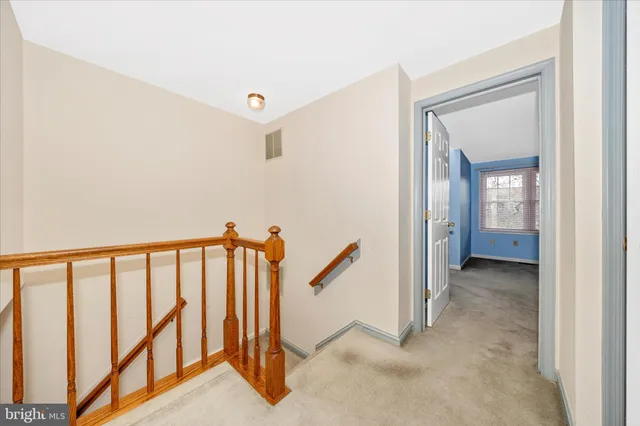 a view of a room with a ceiling fan