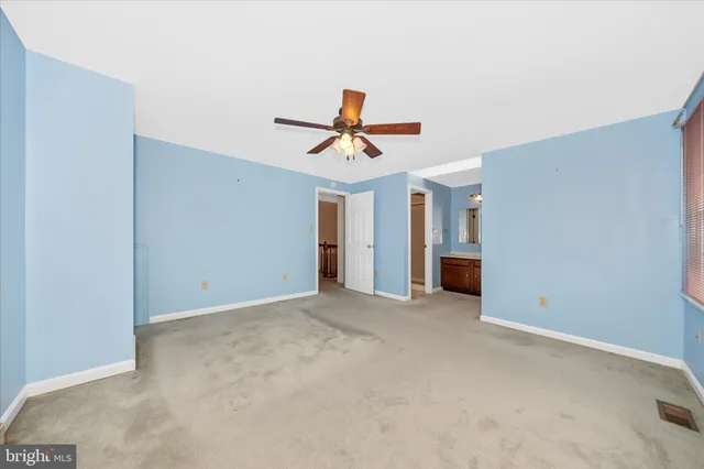 a white toilet sitting next to a bath tub