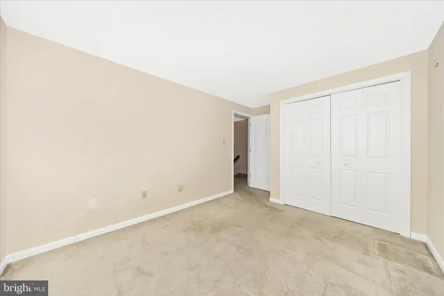 a view of staircase with wooden floor and white walls