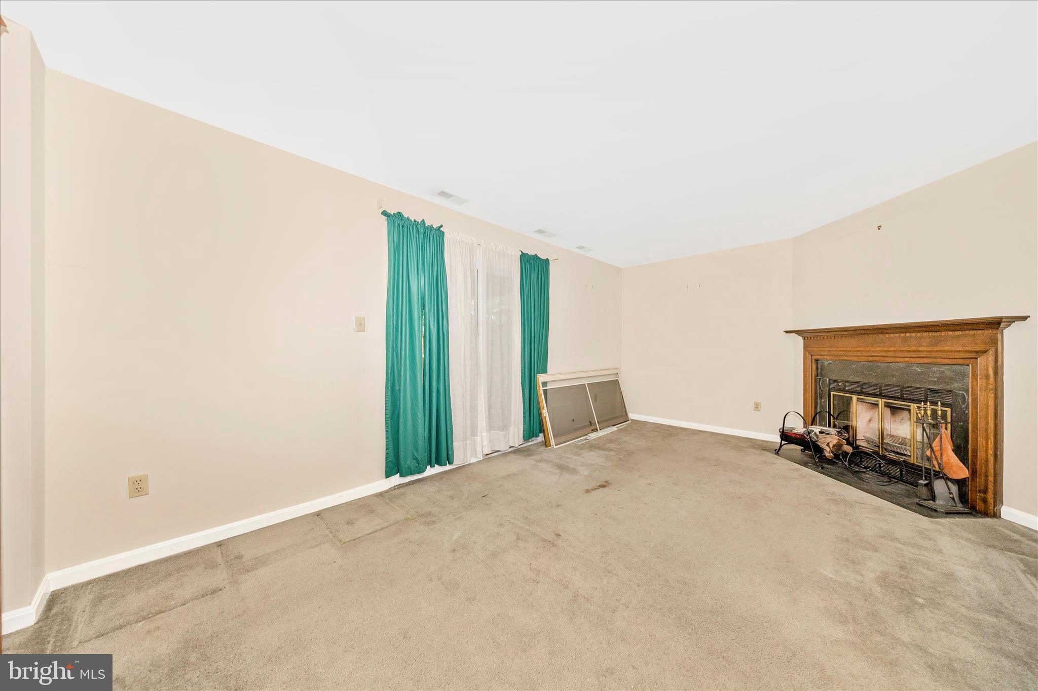 8007 Broken Reed Court Frederick, MD 21701 - Photo 33 of 72 a view of an empty room with a fireplace