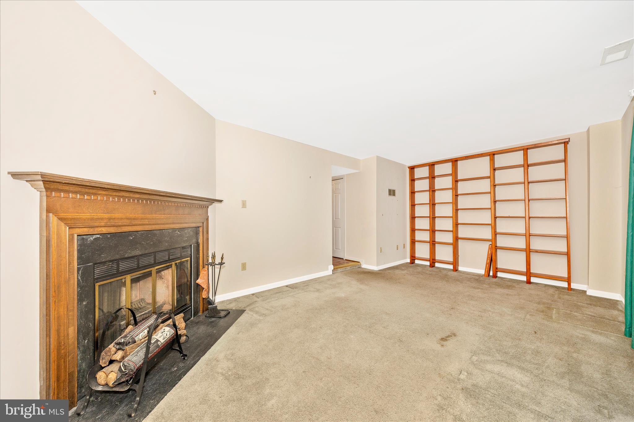 8007 Broken Reed Court Frederick, MD 21701 - Photo 35 of 72 a view of an empty room with a fireplace