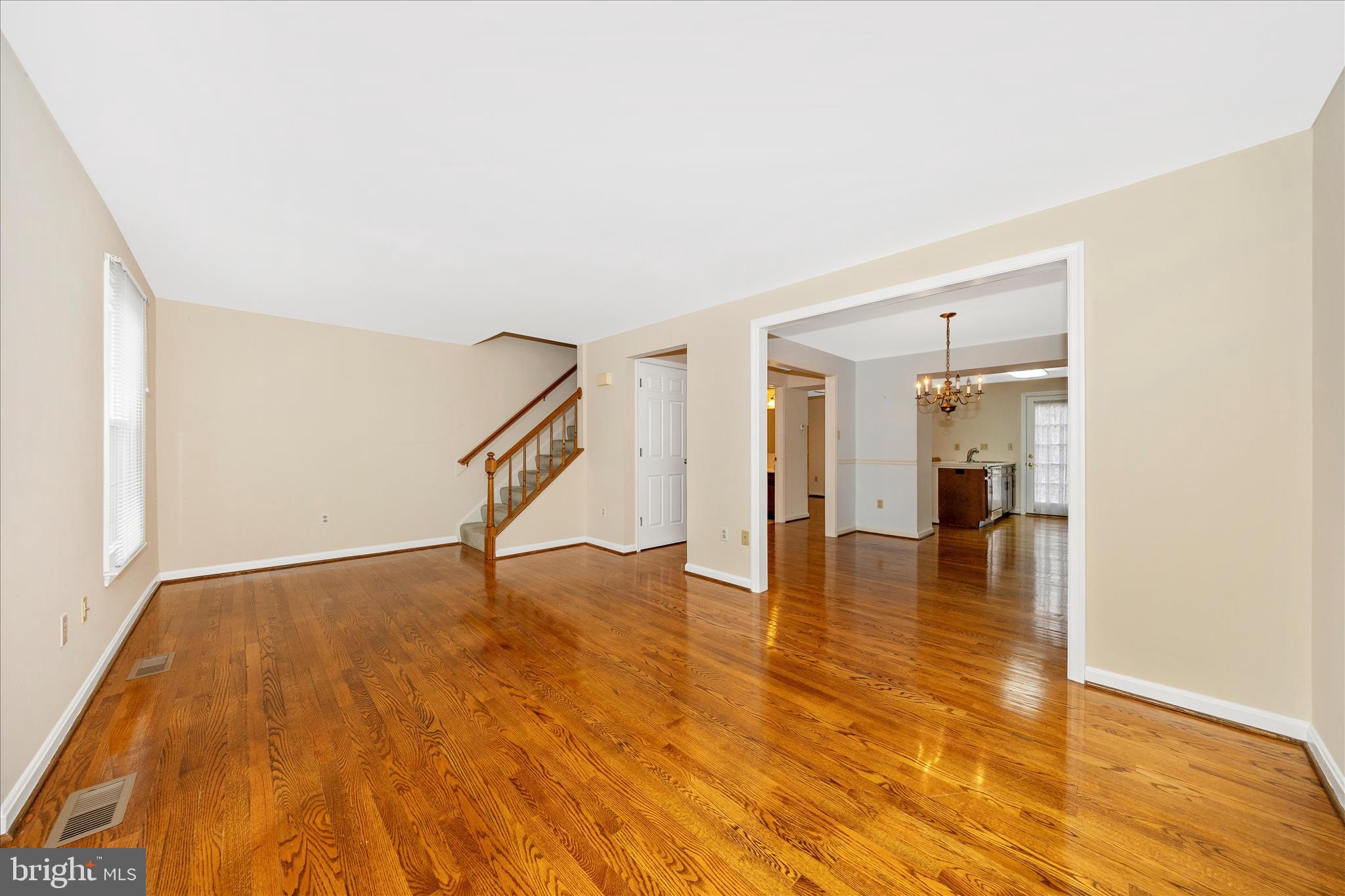 8007 Broken Reed Court Frederick, MD 21701 - Photo 5 of 72 a view of an empty room with wooden floor and a window