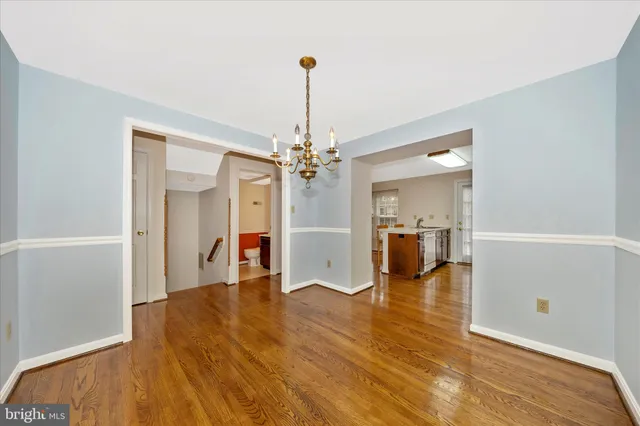an empty room with a window and ceiling fan
