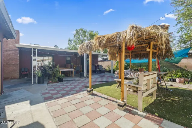 a view of a house with backyard porch and sitting area