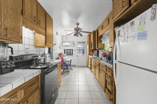 a kitchen with stainless steel appliances a stove a sink and a refrigerator