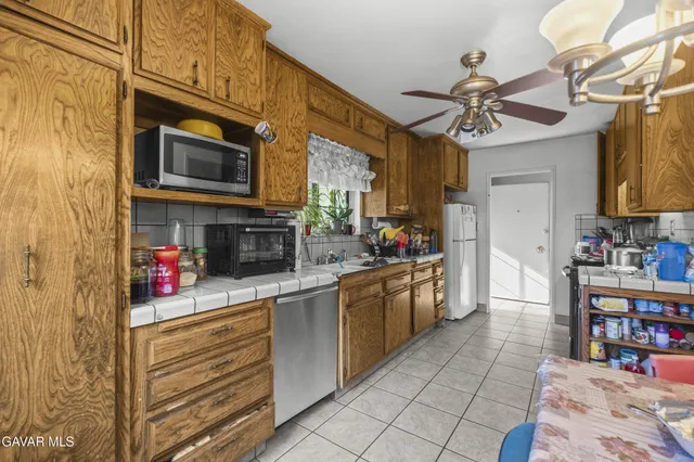 a kitchen with stainless steel appliances granite countertop a stove cabinets and a counter top space
