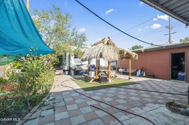 a view of a backyard with plants and a patio