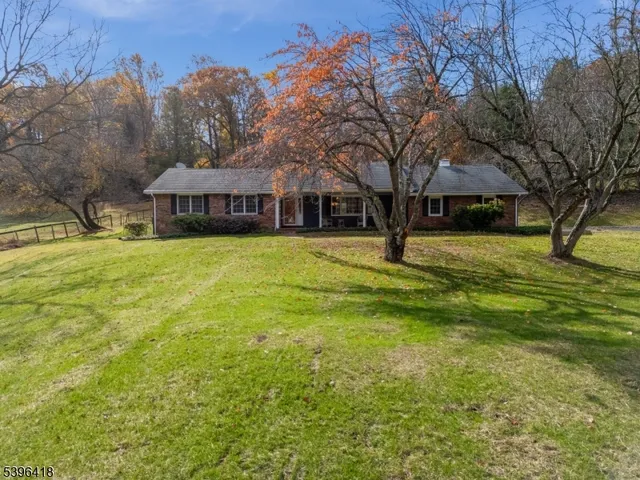 a house with huge green field in front of it