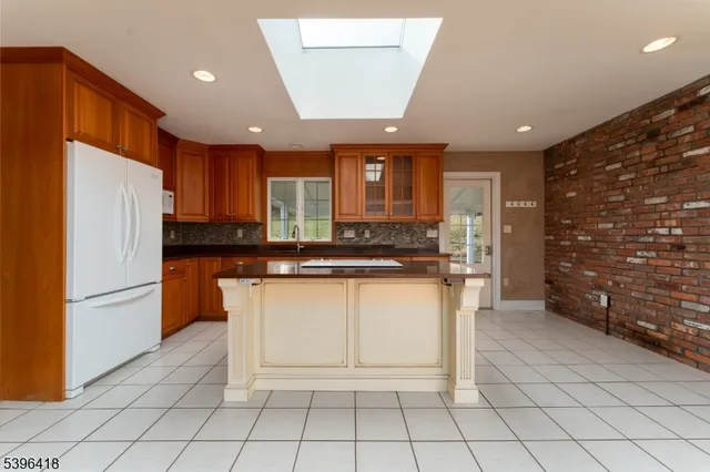 a kitchen with stainless steel appliances granite countertop a refrigerator sink and cabinets