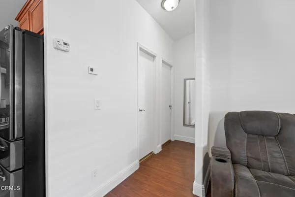 a hallway with furniture and wooden floor