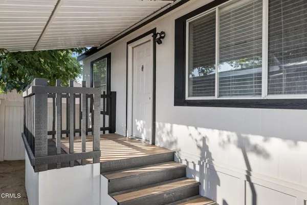 a view of balcony with wooden floor and fence