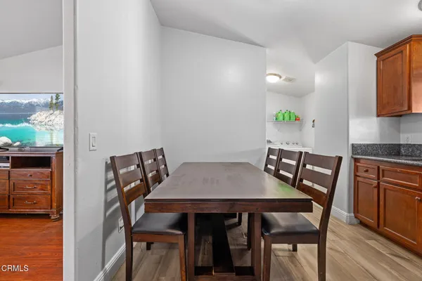 a view of a dining room with furniture and wooden floor