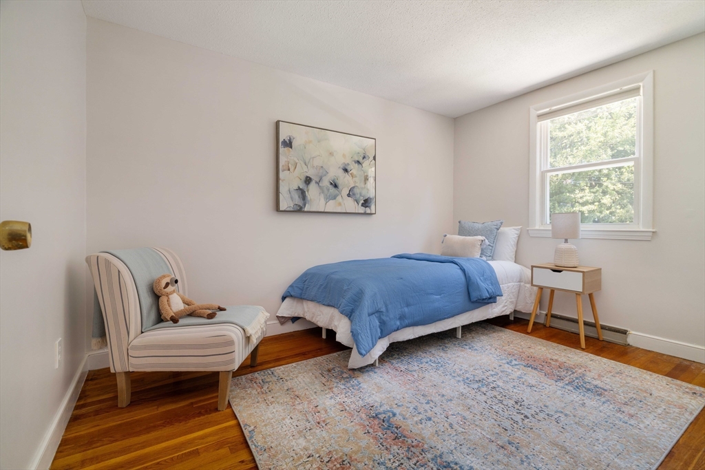 24 Goldsmith Street Boston, MA 02130 - Photo 13 of 23 a bedroom with a bed and a window