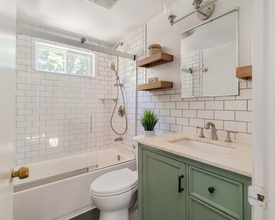 24 Goldsmith Street Boston, MA 02130 - Photo 14 of 23 a bathroom with a granite countertop sink a toilet and shower