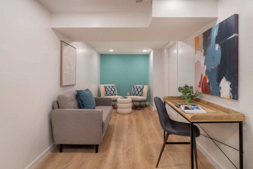 24 Goldsmith Street Boston, MA 02130 - Photo 16 of 23 a living room with furniture and a wooden floor