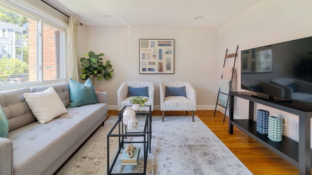 24 Goldsmith Street Boston, MA 02130 - Photo 3 of 23 a living room with furniture a flat screen tv and a large window