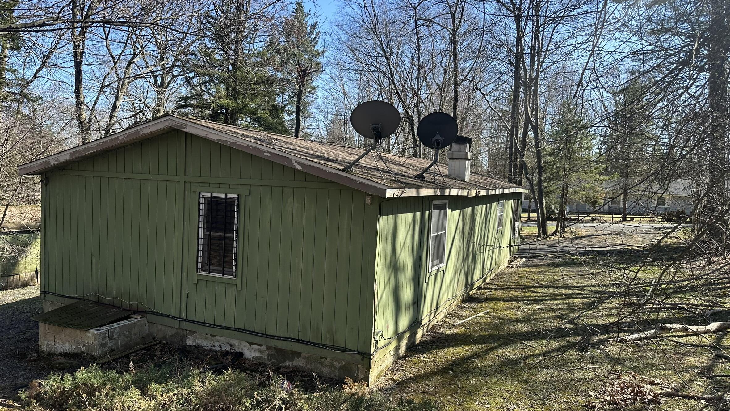 6 Old Post Road Tobyhanna, PA 18466 - Photo 29 of 32 a view of a wooden house with a small yard